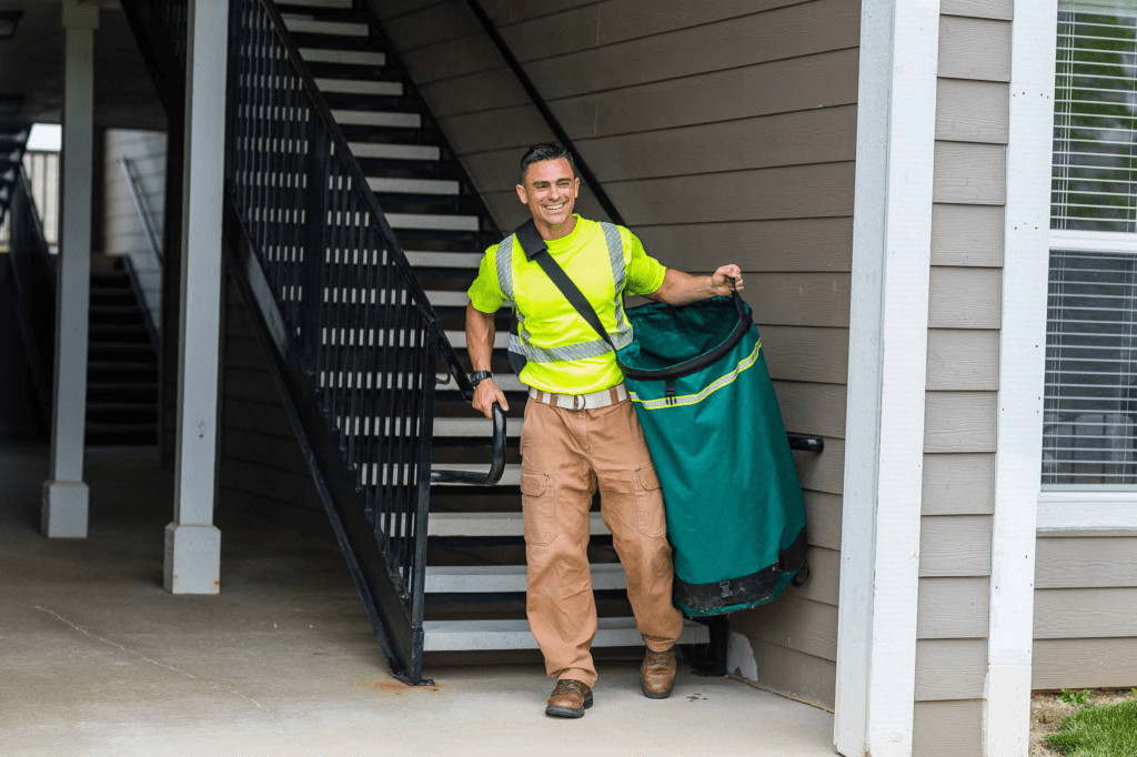 man carrying waste collection bag